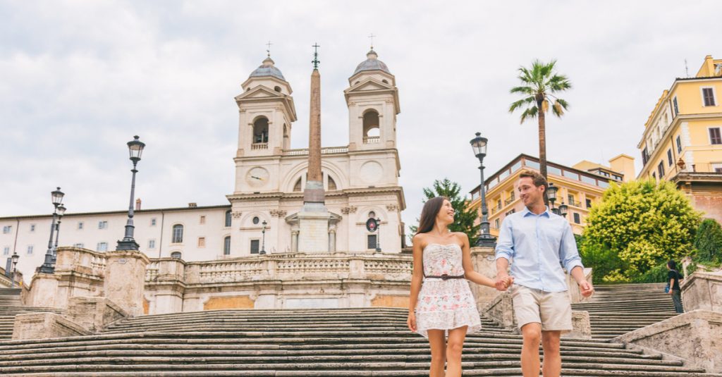 couple walking down stairs in historic Italian city.