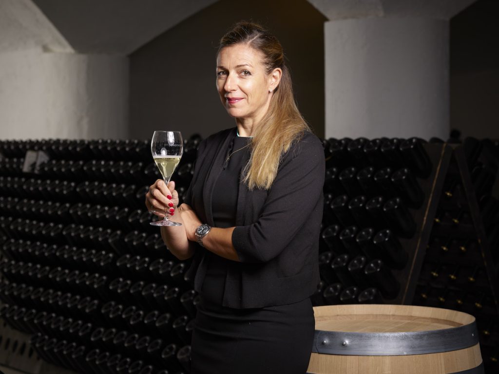 Sabrina Schench director of Trentodoc holding glass of sparkling wine.