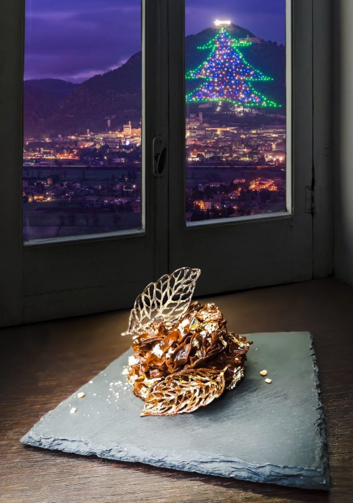 sweet dessert in front of window with christmas tree of gubbio