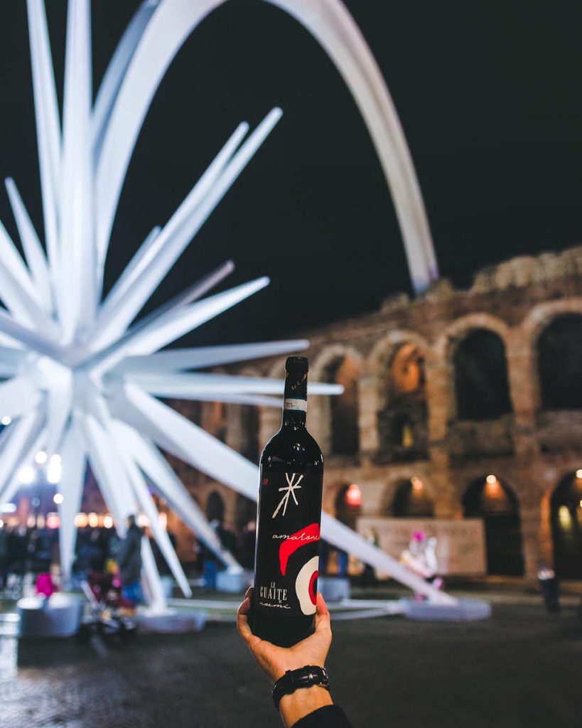 Verona arena with wine bottle in front