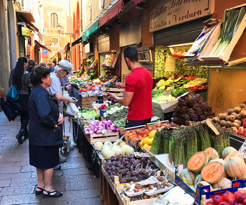 men and women shopping the market in Bologna