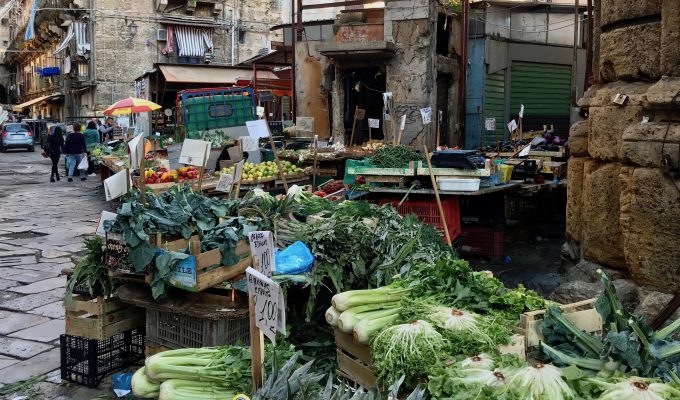 Dirty street wiith vegetables ono table