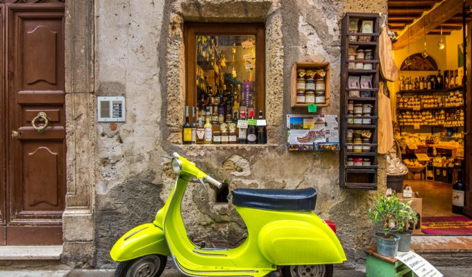 vacation in Italy Vespa in front of wine shop