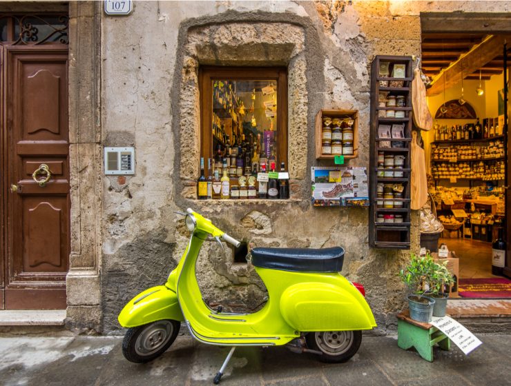 vacation in Italy Vespa in front of wine shop