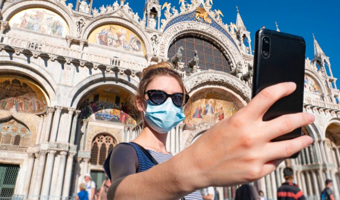 safe travel list: woman visiting Italy takes selfie in Milan