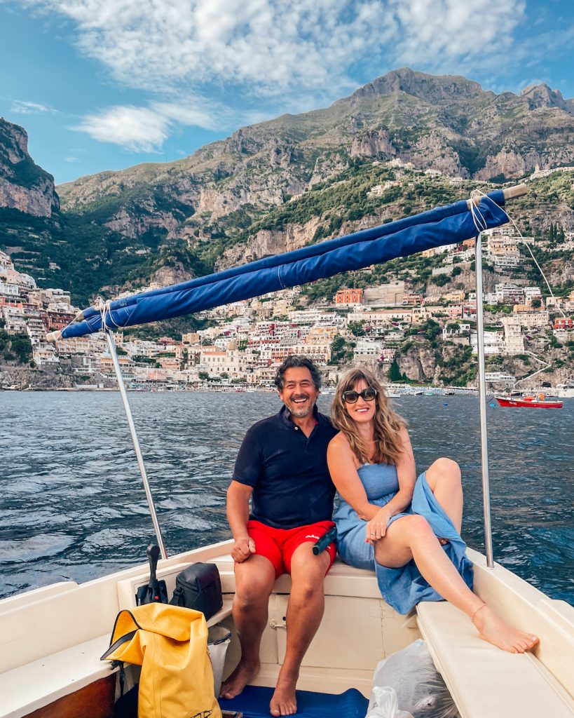 Nicki Positano: NIcki Storey with Carlo in aboat with Positano in the background