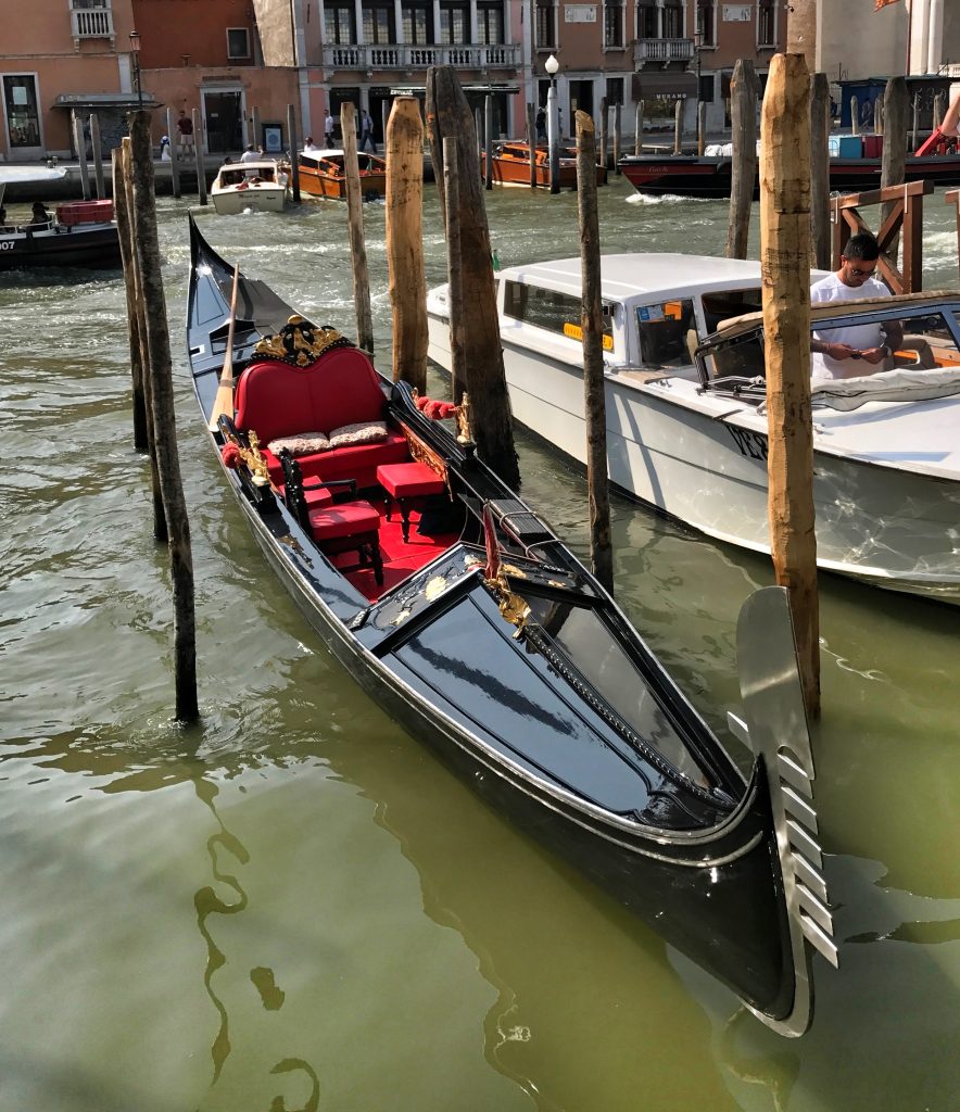 Gondolas docked in a Venetian canal.