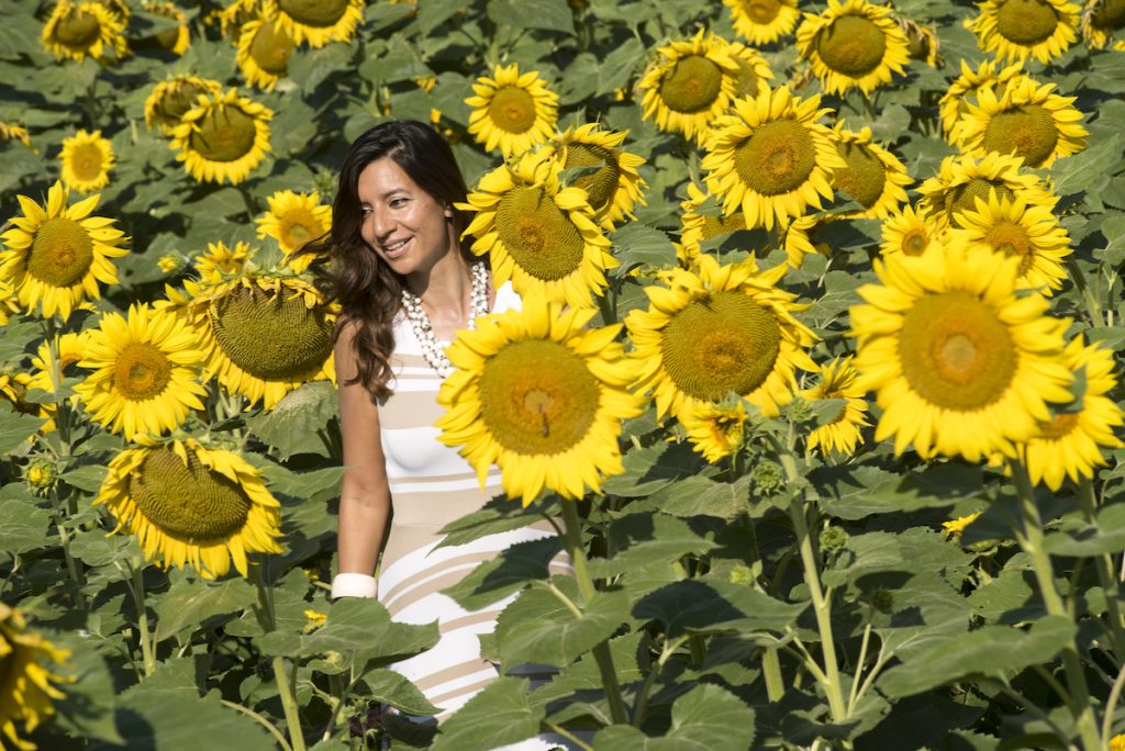 Slow living in Le Marche - woman in sunflower field Julian de Brito