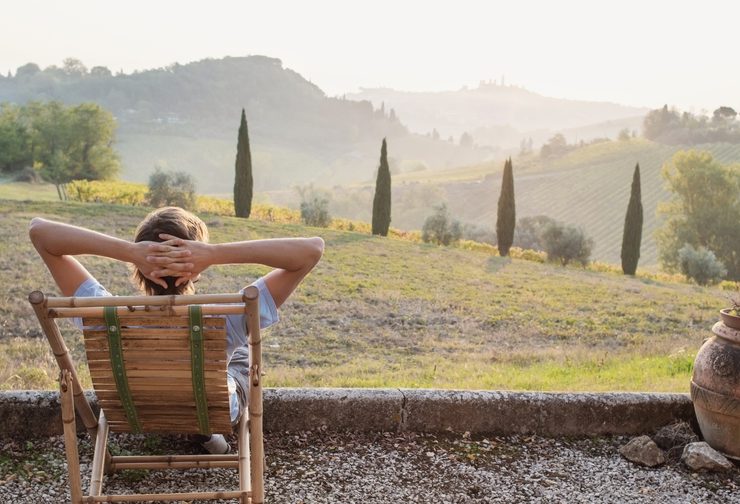 September in Italy man relaxing overlooking Tuscany countryside