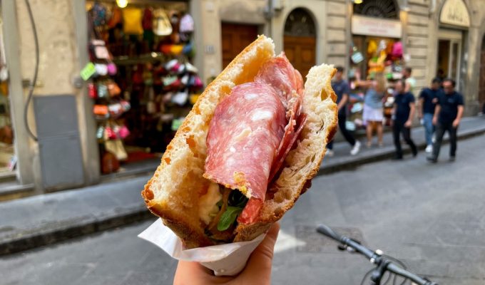 eat in florence - hand holding panino on florence street