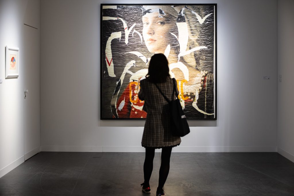 woman looking at art - top Italian art galleries seen at Art Basel Miami Beach
