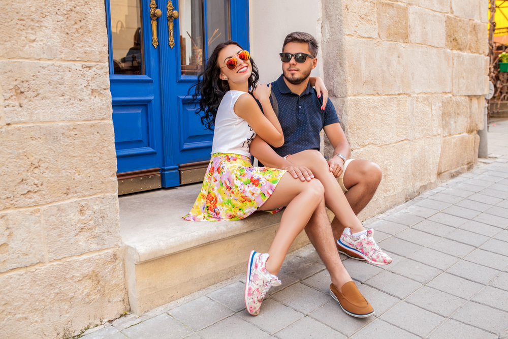 young stylis couple wearing sunglasses on Italian street