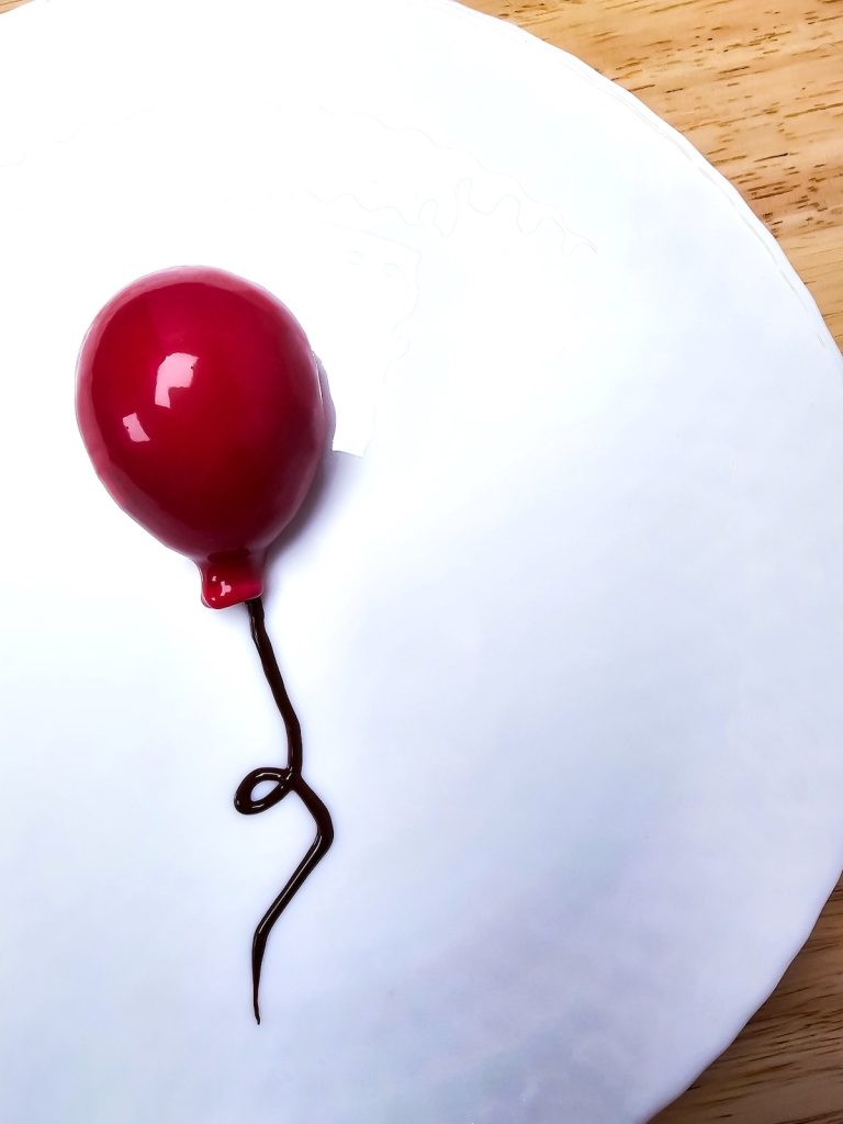 Tiramisu Balloon - dessert shaped like a balloon on a white plate
