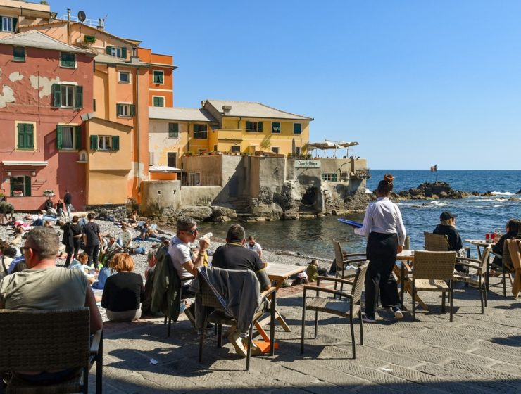 people sitting on beach in Liguria on Easter Monday Pasquetta