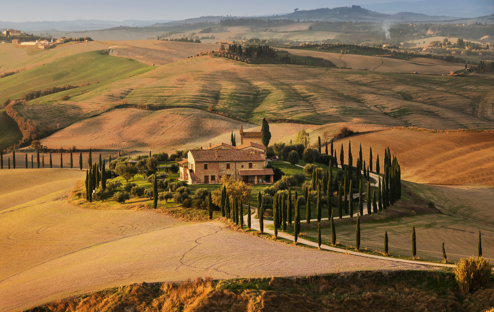 Villa in Tuscany with Cypress trees lining the road