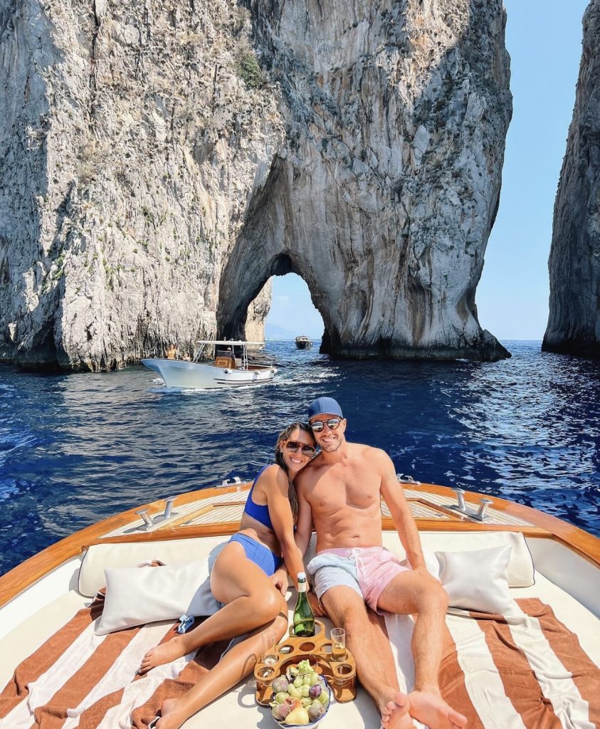 young couple on private charter boat in the Amalfi Coast.