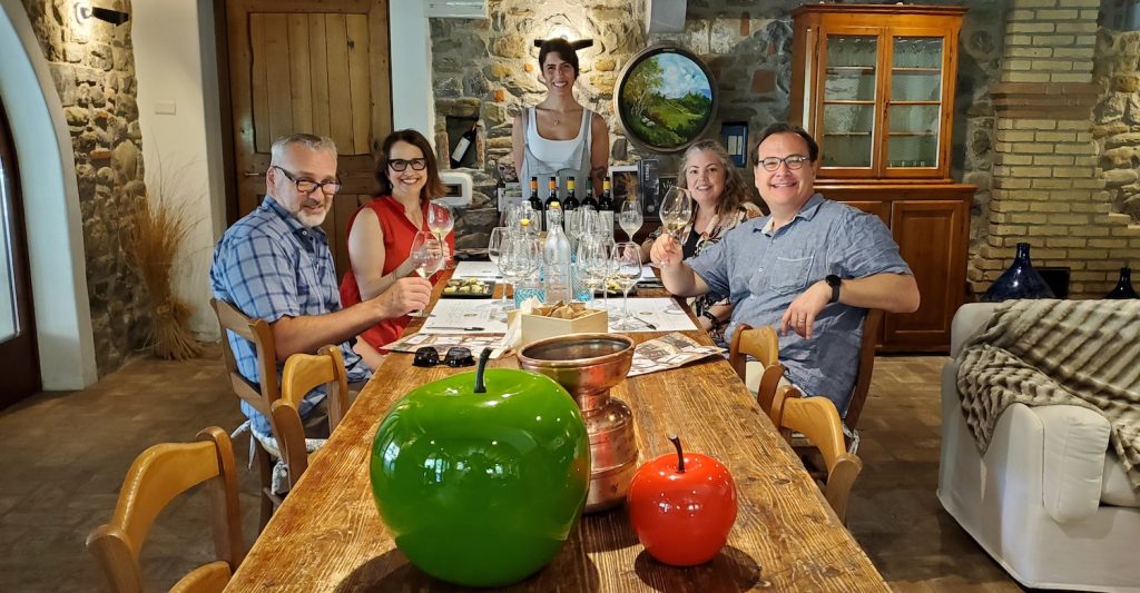 group of tourists enjoying a dinner and wine experience in Italy