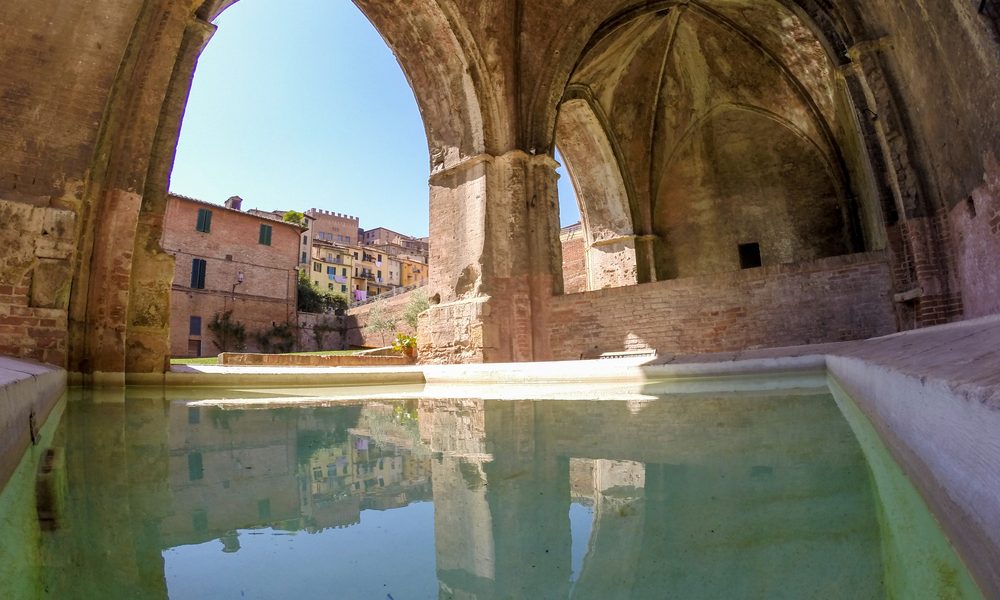 Water pool inside ancient Fontebranda fountains in Siena, Italy