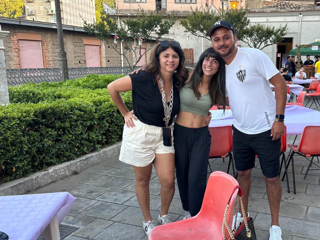 Consuelo Damigo , Feuza Reis and Max pose for a photo at Piazza