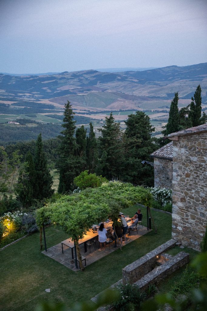 Monteverdi Tuscany - people enjoying outside dining at sunset overlooking Tuscany