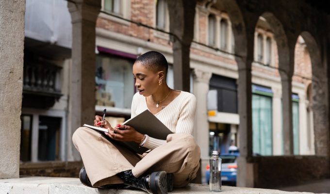 Italian digital nomad visa: woman writing in notebook