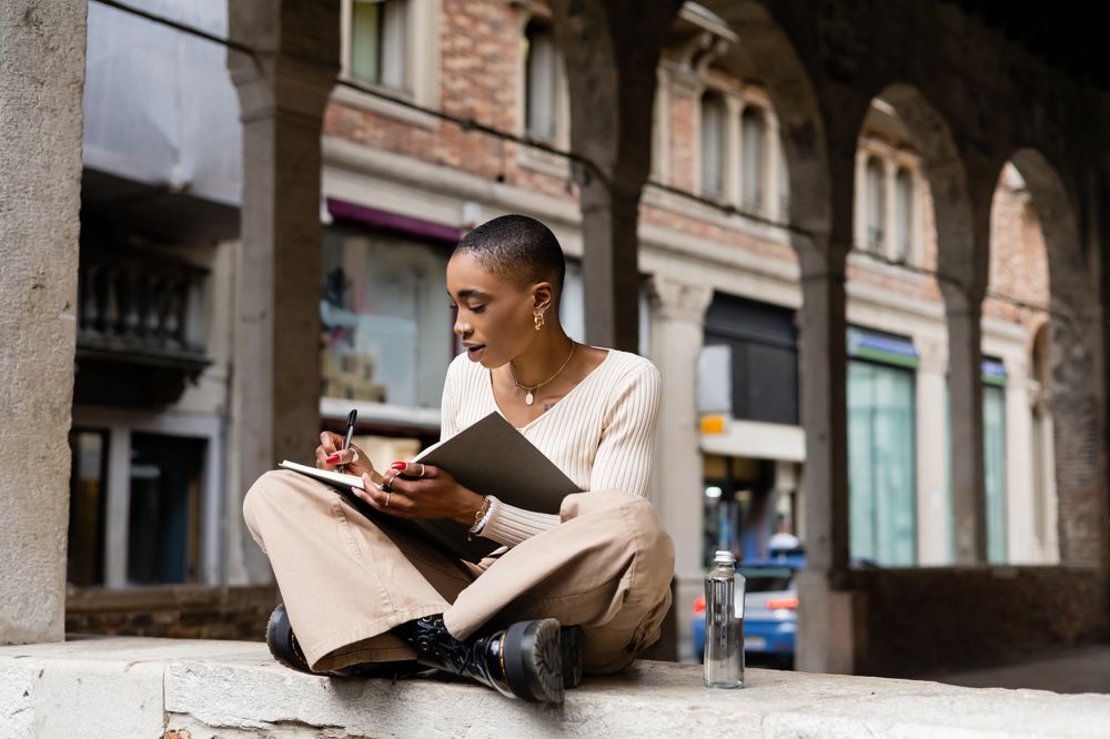 Italian digital nomad visa: woman writing in notebook