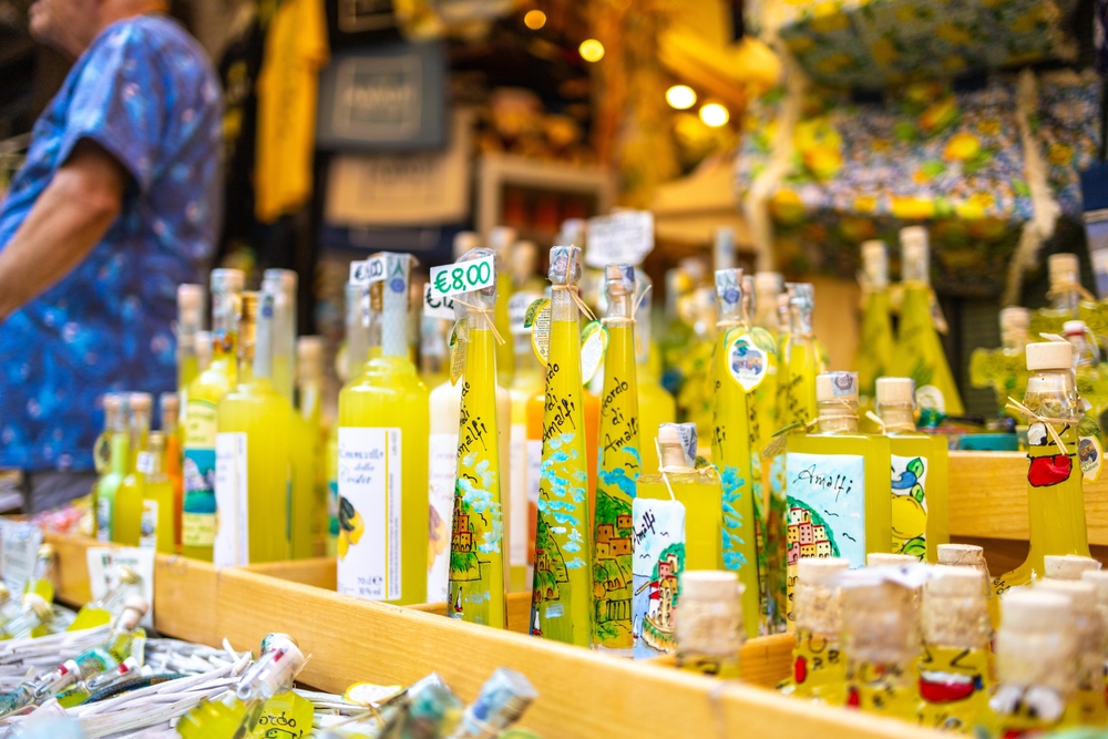 Amalfi Coast Cocktail Week: bottles of limoncello with yellow Amalfi Coast decor