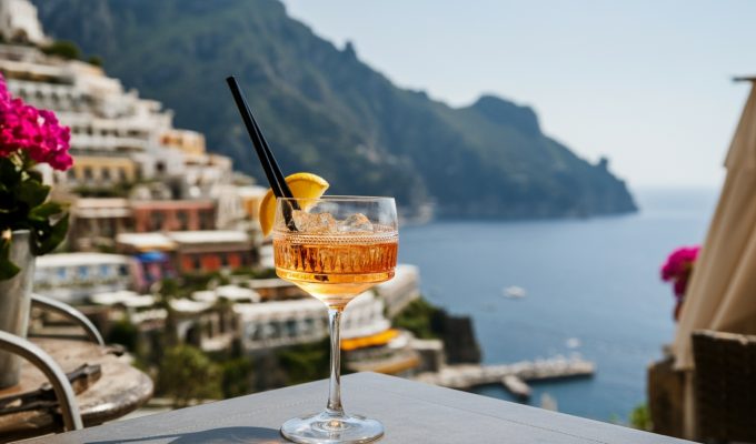 Amalfi Coast Cocktail Week: cocktail on table with Positano in the background