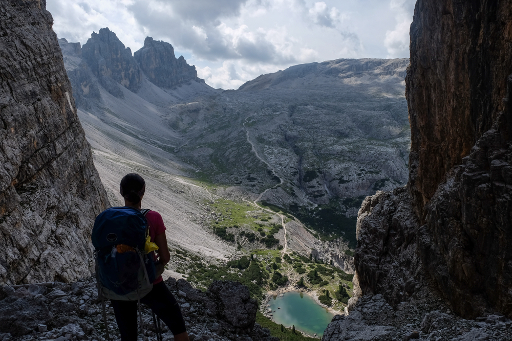 Hiking trails in Italy - hiker overlooking Alta Via 1 in the Dolomites