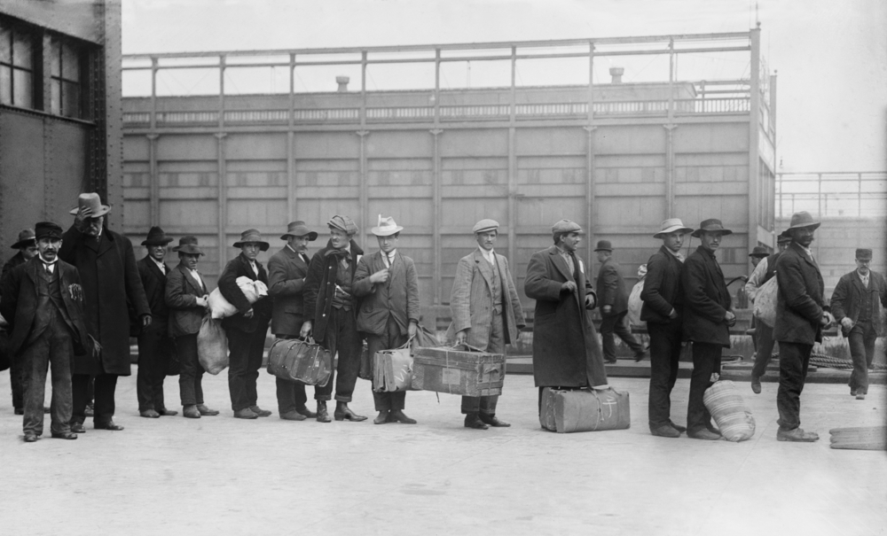 Ellis Island - archive photo of Italian men lining up to t be processed.