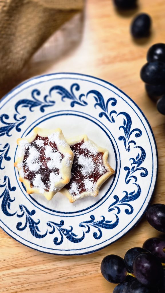 Pitteddhe - start shaped cookies on plate with grapes