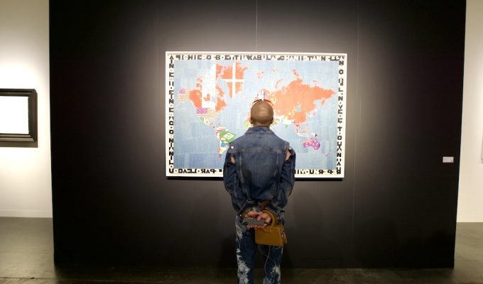 man looking at art - map Art Basel Miami Beach 2024