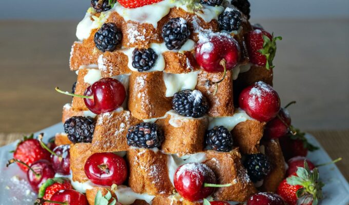 Pandoro Christmas tree dessert for easy Italian holiday entertaining with whipped cream and berries.