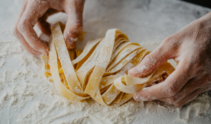hands making pasta flour