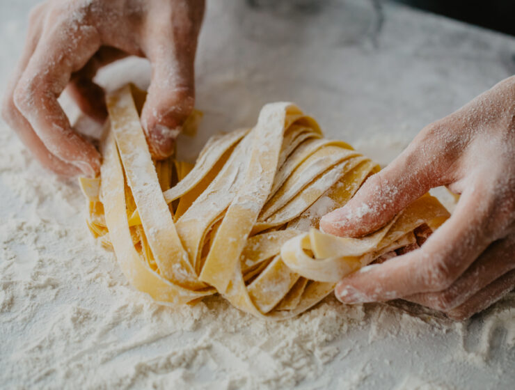hands making pasta flour