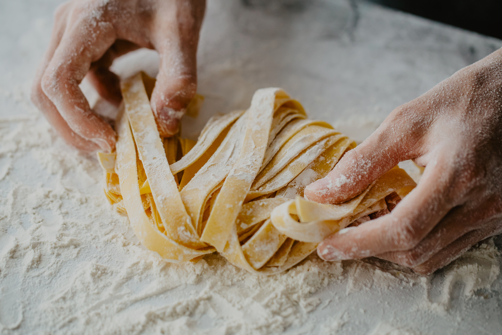 hands making pasta flour