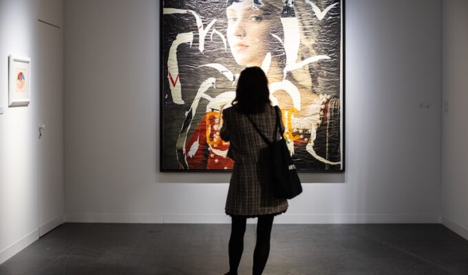 woman looking at large painting at Art Basel Miami Beach