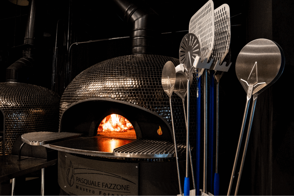 The restaurant's wood-fired pizza oven crafted by Italian masons using stone sourced from Italy.