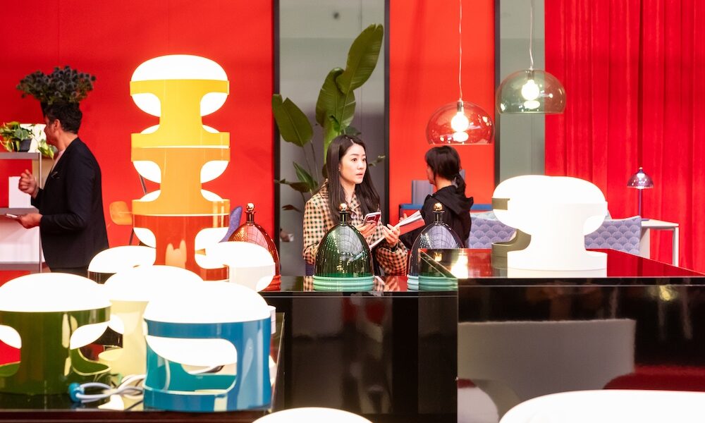 Salone del Mobile. Milano 2026 exhibitor booth with bright red and attendees