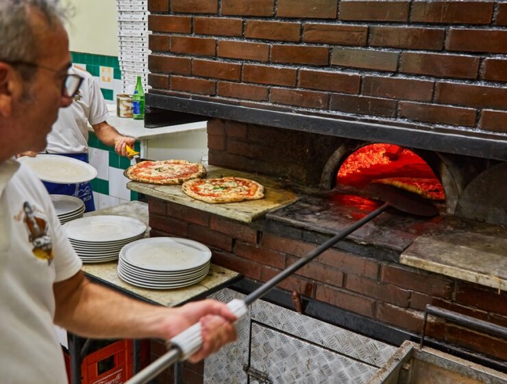 L'Antica Pizzeria da Michele. Naples pizzeria. Naples, Italy. Man making Neopolitan pizza in a wood oven.