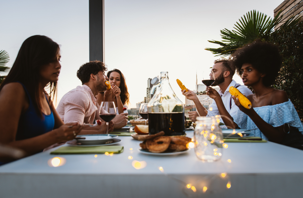 friends enjoying wine at sunset