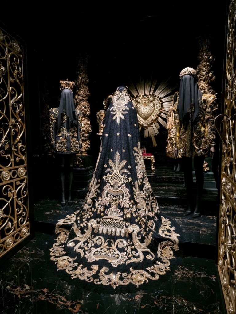 Gold and black devotional-inspired Dolce & Gabbana garments displayed in From the Heart to the Hands: Dolce & Gabbana at ICA Miami, reflecting Italian religious symbolism and Baroque craftsmanship.