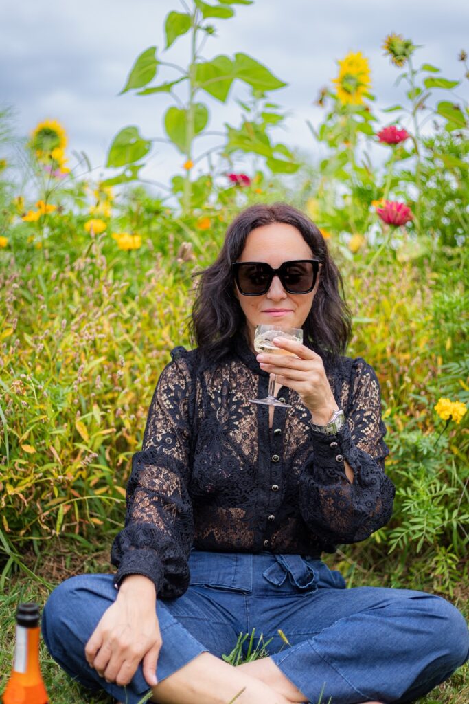 Daniela Sfara in a sunflower field reflecting on Slow Food philosophy and Italian cultural traditions