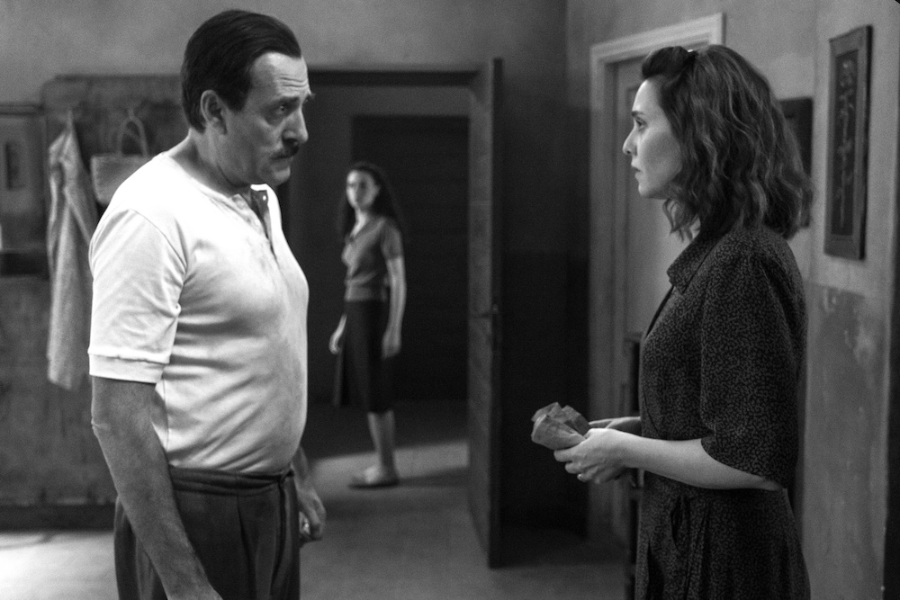 Tense black-and-white scene from C’è Ancora Domani featuring Delia and her husband inside their family home.