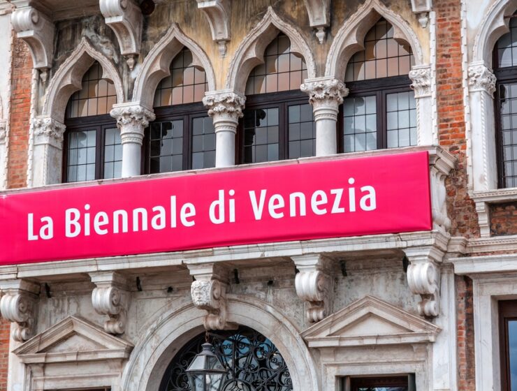 Sign of the annual Venice Biennale in Italian Language, hung on a palazzo wall.