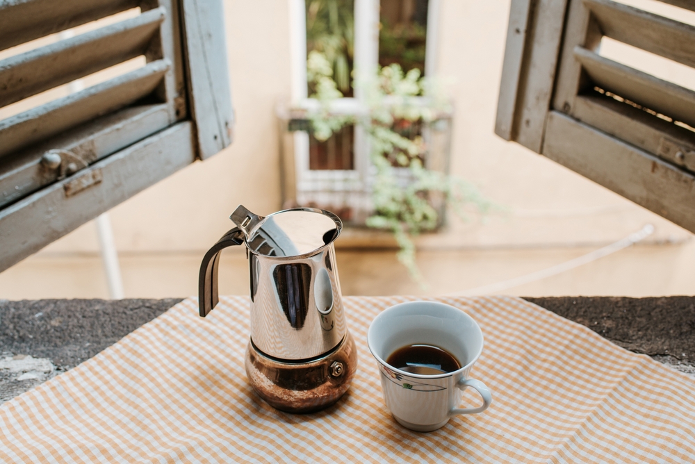 espresso maker and espresso in Italy - vintage shutters and balcony