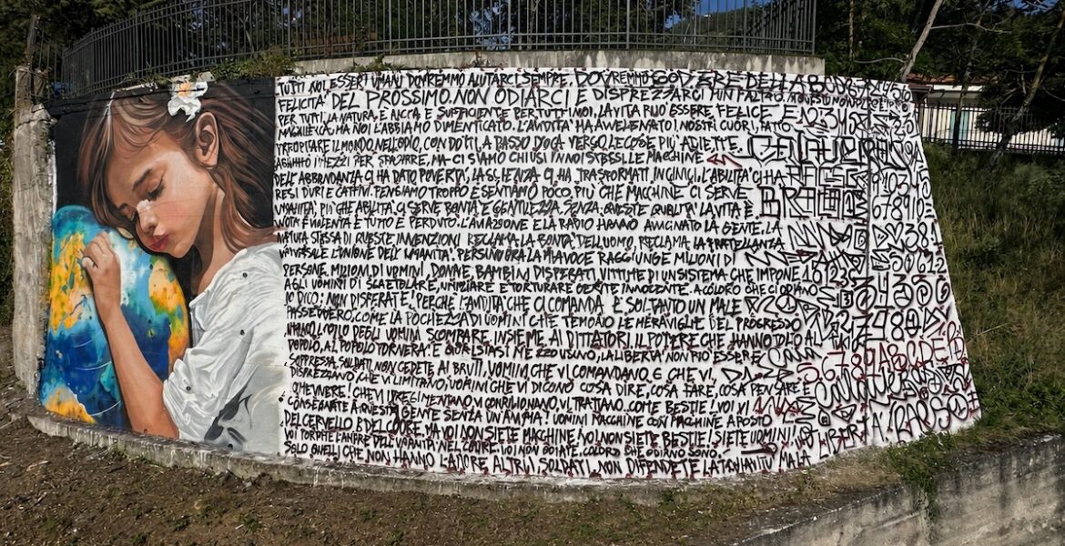 The "Oltre il Muro" mural takes shape in Sasso di Castalda, Basilicata, Italy.