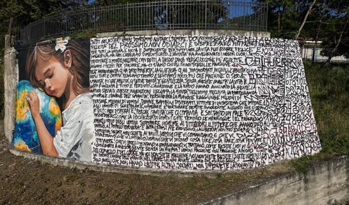 The "Oltre il Muro" mural takes shape in Sasso di Castalda, Basilicata, Italy.