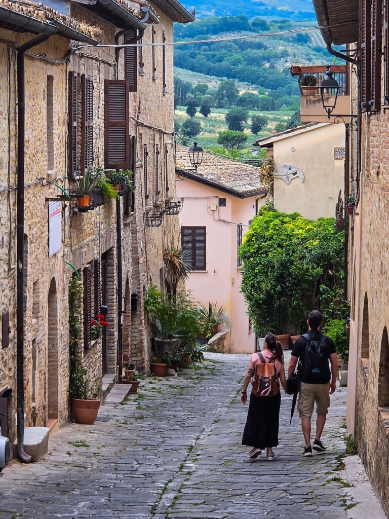 Visitors walking through a historic stone street in Bevagna, one of Umbria's most beautiful medieval villages