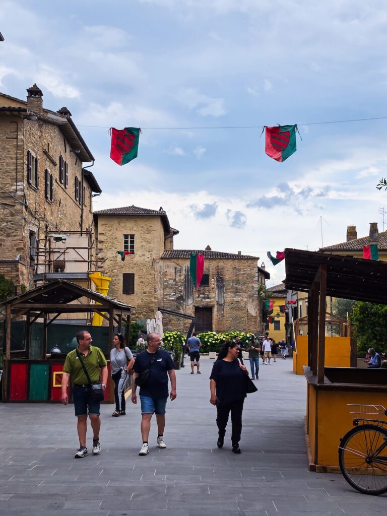 Piazza in Bevagna, Umbria, decorated with traditional banners during the summer season
